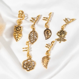 Retro gold spiral hair charms set with leaf and rose pendants on white silk background