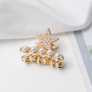 Détails de la mini pince à cheveux dorée avec motif d'étoile et perles blanches