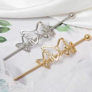 Elegant gold and silver metal butterfly hair pins for stylish bun hairstyles on white silk