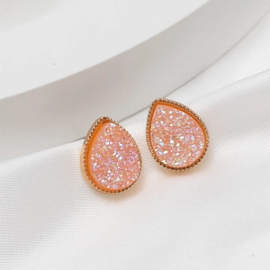 Minimalist peach pink waterdrop stud earrings with rose gold textured frame and crystals