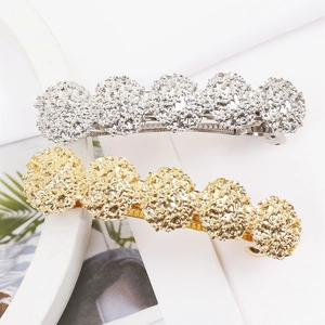 Elegant gold and silver spring hair clips with textured circular floral metallic design