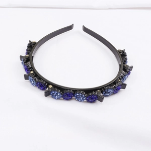 Detail of black non-slip headband with multiple blue rhinestone flower clips for styling