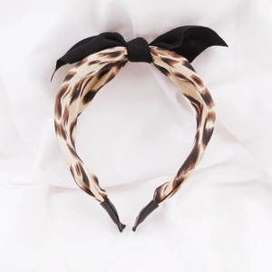 Serre-tête léopard pour filles avec un nœud noir élégant sur une base en tissu confortable