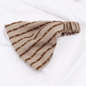 Detailed view of elastic pleated back design on striped knitted headband for a flexible fit