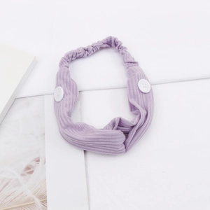 Detail of purple ribbed headband with white buttons for mask ear relief on clean background
