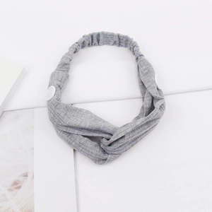 Close-up of gray ribbed knit headband with white buttons for mask and twist knot detail