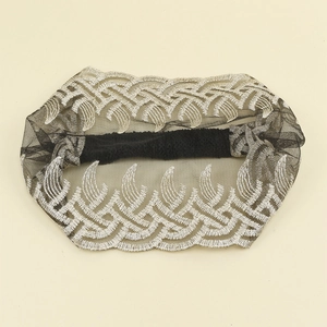 Detail of vintage striped knit headband showing silver wave embroidery and elastic black band