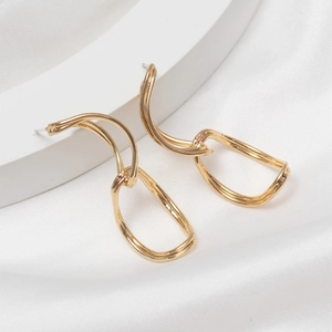 Polished gold geometric S925 silver needle earrings on white silk fabric background