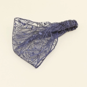 Detail of navy blue lace headband showing textured mesh fabric and elastic band