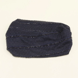 Detailed texture of navy lace headband with silver tinsel stripes and elastic knit fabric