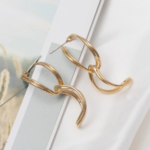 Polished gold S925 sterling silver post double hoop earrings on white satin fabric