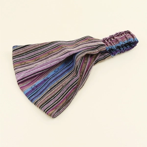 Close-up of wide striped knitted elastic headband with colorful textured fabric details