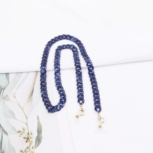 Close-up of blue marble acrylic glasses chain with gold lobster clasps and rubber loops