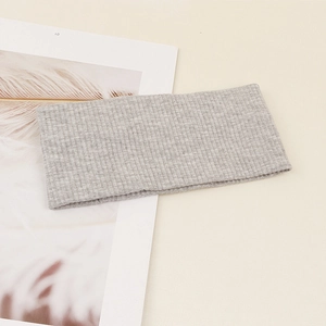 Detail of grey ribbed knit headband showing soft texture and elastic fabric for yoga