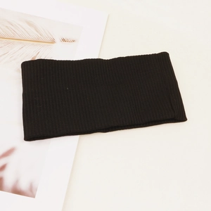 Detailed texture of black ribbed knit headband with elastic yoga sports fabric