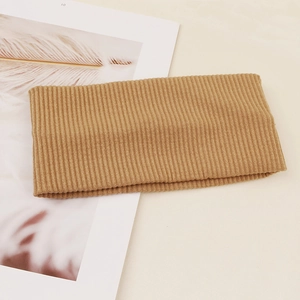 Macro detail of khaki ribbed knit elastic headband showing high quality fabric texture
