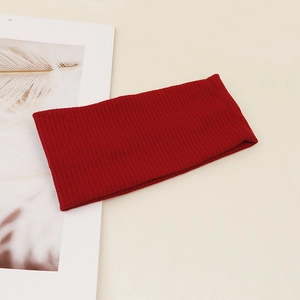Detail view showing red ribbed knit texture on stretch yoga headband for women