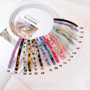 Flat lay of eighteen assorted acetate hair clips in leopard and marble patterns
