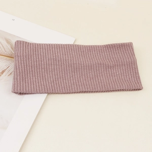 Detailed close-up of rose pink ribbed knit headband featuring elastic seamless wide brim