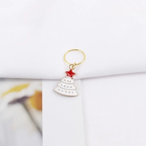 Detailed close-up of Christmas tree pendant hair ring with white oil drip and red star