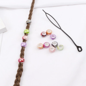 Detailed close-up of mixed acrylic hair rings and professional styling loop tool