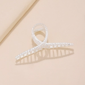 Silver twisted metal hair claw clip with hammer texture and minimalist geometric design