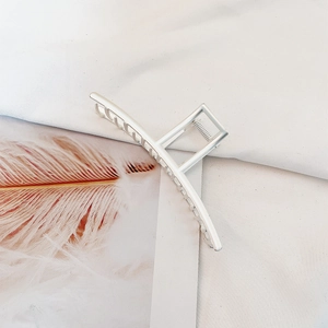Detailed view of silver minimalist metal hair claw clip with smooth polished finish