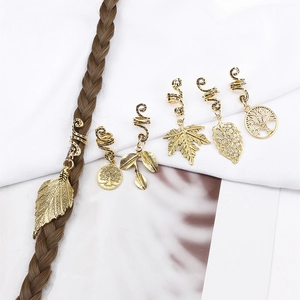 Detail view of 6-piece golden alloy dreadlock hair rings with tree and leaf pendants