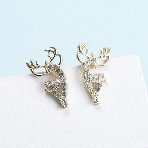 Eleganti orecchini a lobo a forma di renna dorata con strass bianchi su sfondo chiaro