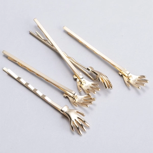 Set of 4 gold palm-shaped wave metal hairpins with polished finish for unique hairstyling