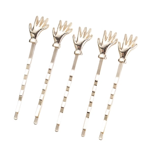Set of five gold wave-shaped hair clips with unique palm hand design in minimalist metal