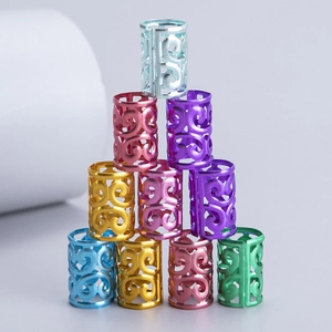 Macro shot of 10 colorful aluminum dreadlock cuffs with intricate filigree pattern