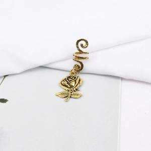 Detail view of retro gold rose charm hair ring with spiral texture for dreadlocks