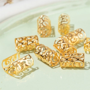 Macro view of gold hollow-out filigree scroll pattern hair ring beads for dreadlocks