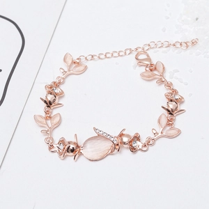 Detail view of cat eye stone leaf and rose gold flower bracelet with sparkling zircon