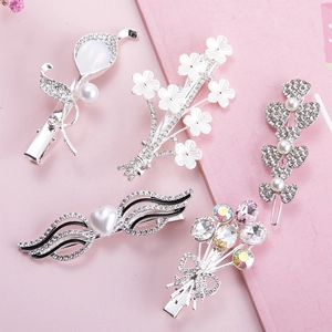 5-piece set of Japanese style hair clips with faux pearls, flowers and crystals on pink background