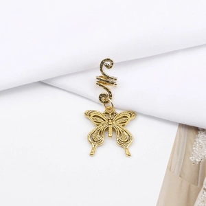 Detail view of a vintage gold alloy spiral hair ring with a hollow butterfly pendant charm