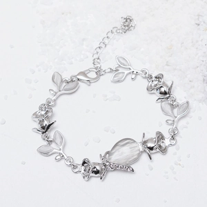 Detailed shot of silver-tone leaf and rose bracelet with cat-eye stones and lobster clasp