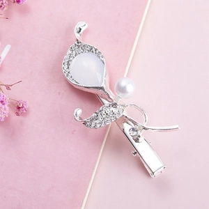 Detailed shot of silver flower hair clip with pear-shaped gem and sparkling rhinestones
