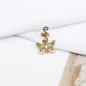 Detailed view of a golden alloy butterfly pendant attached to a spiral hair ring