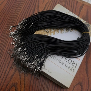 Close-up of black waxed cord necklaces with silver lobster clasps and extension chains