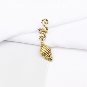 Macro detail of antique gold spiral dreadlock bead with a realistic seashell pendant