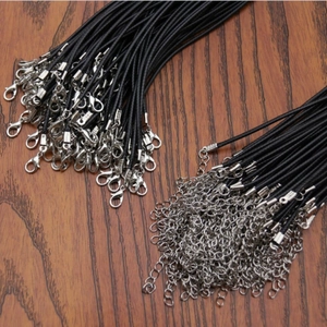 Close-up of black waxed cord necklaces with silver lobster clasps and extension chains