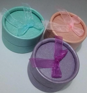 Three-piece set of round pastel jewelry boxes with pearl paper and organza bow details