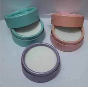 Three-piece cylindrical jewelry gift boxes in pastel green, pink, and lilac with textures