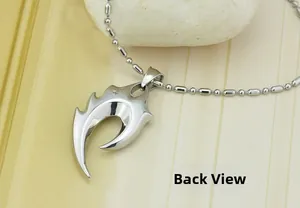 Polished silver skull flame pendant with ball chain shown from the detailed back view