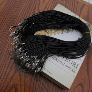 Bulk set of black wax cord necklaces with lobster clasps and extension chains on a wooden desk