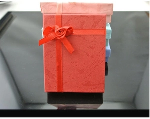 Textured jewelry gift boxes with ribbon roses in red, pink, blue and navy colors