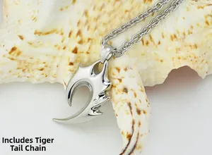 Detail of tribal silver pendant with clear zircon stone and tiger tail chain