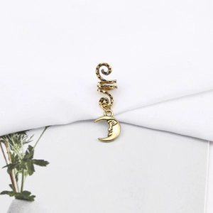 Detailed view of bronze spiral hair coil featuring a crescent moon face charm and a vintage feel